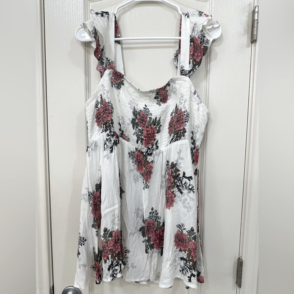 White tunic shirt from torrid size 1x. It is white with pink flowers on it.